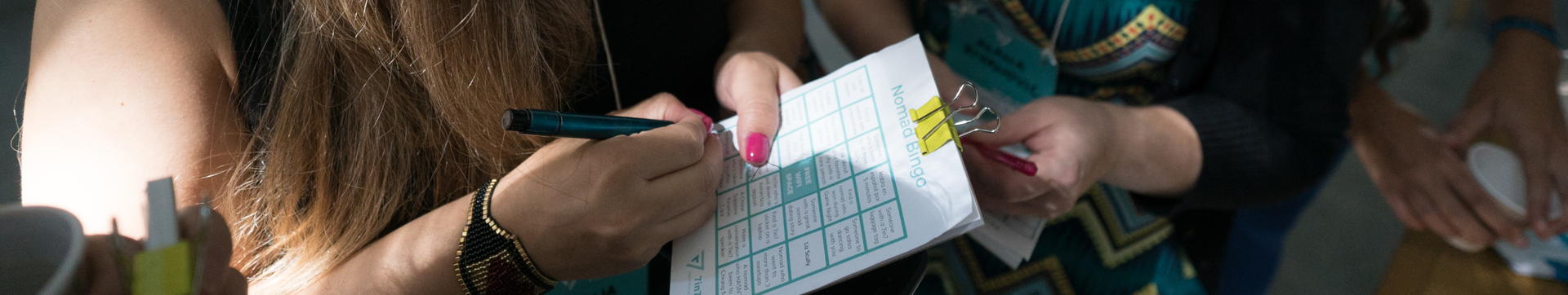 A 7in7 Year Three attendee filling out a Nomad Bingo card