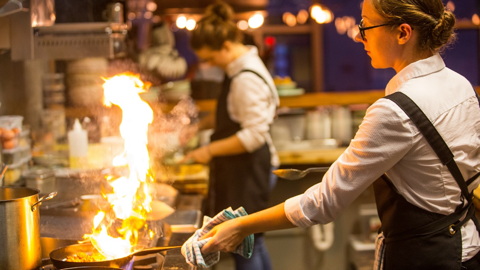 A chef cooking in a fancy kitchen